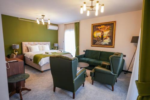 a hotel room with a bed and a couch at Aurelius Hotel & Restaurant in Pljevlja