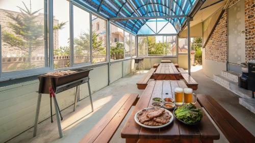 a row of tables in a building with food on them at Samcheok Eoulim Pension in Samcheok