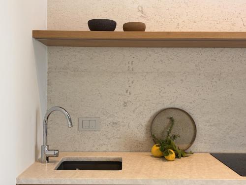 a kitchen counter with a sink and a mirror at KITO suites in Kitriaí