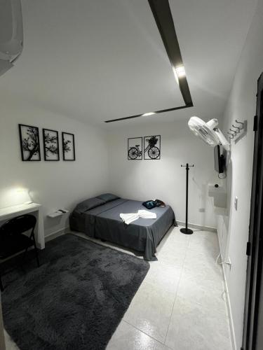 a bedroom with a bed and a desk in it at Apart Hotel miwi in Los Patios