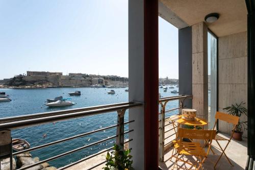 a balcony with a view of a body of water at St Angelo Mansions 3BDR flat with Seaview in Vittoriosa