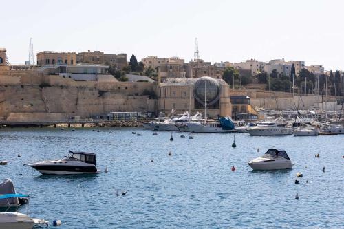 a group of boats in the water in a harbor at St Angelo Mansions 3BDR flat with Seaview in Vittoriosa