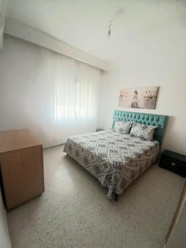 a bedroom with a bed and a dresser in it at galaxy home in Nabeul