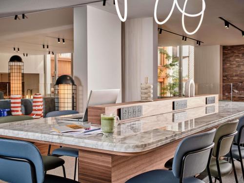 a conference room with a large table and chairs at TRIBE Paris Pantin in Pantin
