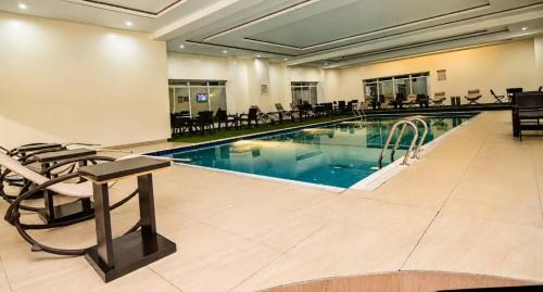 a pool in a hotel with chairs around it at Corporate Residence in Port Harcourt