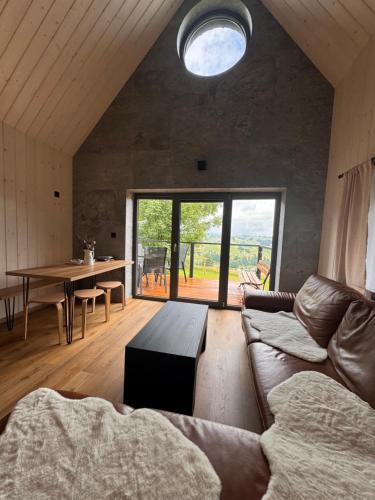 a living room with a couch and a table at Chata Slovena in Novoť