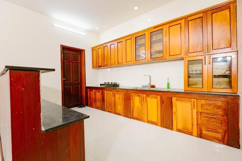 a kitchen with wooden cabinets and a counter top at BTLk D16- 27-02 in Thủy Triều