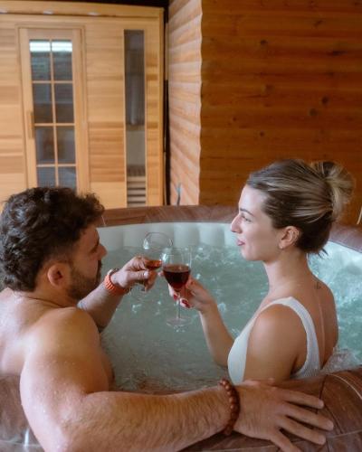 a man and woman drinking wine in a bathtub at Green therapy - Wellness resort in Bet Dagan