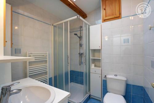 a bathroom with a shower and a toilet and a sink at Les chaillées in Saint-Romain-en-Jarez