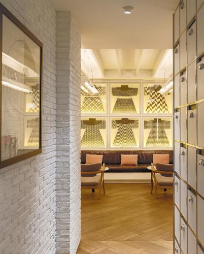 a wine cellar with chairs and a bench in a room at H10 Universitat in Barcelona