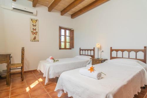 two beds in a room with white sheets at Mercader in Alcudia