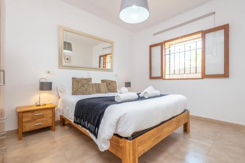 a bedroom with a large bed and a mirror at Raco De Can Pep in Inca