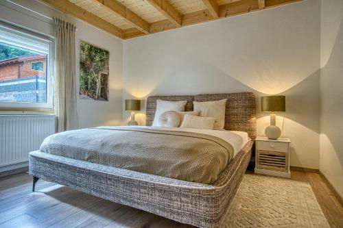 a bedroom with a large bed with two lamps at Ferienhaus Immenhof in Rieden