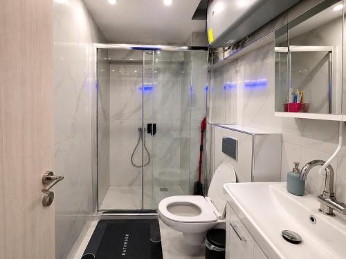 a bathroom with a shower and a toilet and a sink at D4 Apartments Paralia No-5 in Paralia Katerinis