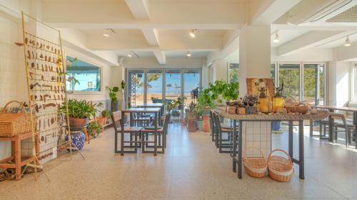 a room with tables and chairs and windows at Yangyang Bono Pet-friendly Pension in Yangyang
