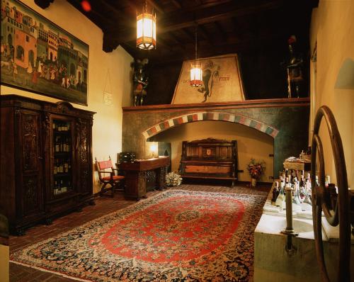 a living room with a fireplace and a rug on the floor at Castello Di Pavone in Pavone Canavese
