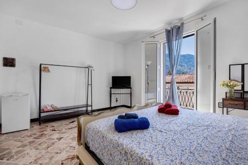 a bedroom with a bed with two towels on it at The Nice Bright House in Palermo