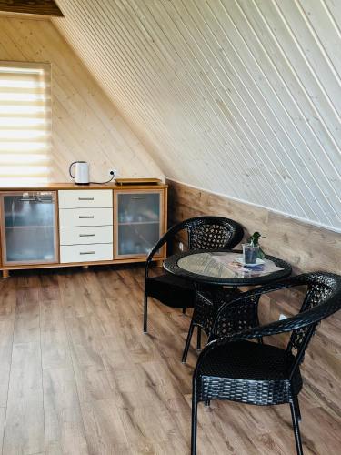 a room with two chairs and a table and a counter at Ezermala in Dagda