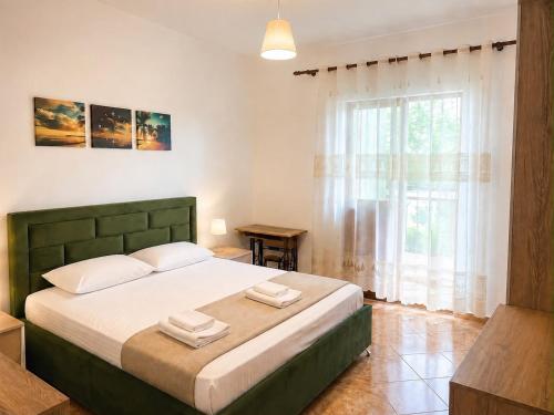 a bedroom with a bed with two towels on it at Villa Ajla- Entire Villa in Durrës