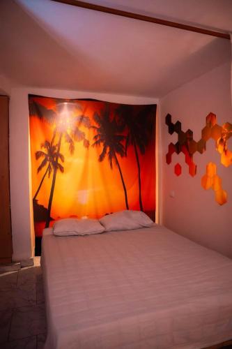a bedroom with a bed with palm trees on the wall at Green therapy - Wellness resort in Bet Dagan