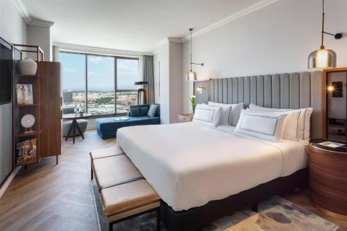 a bedroom with a large bed and a living room at Meliá Valencia in Valencia