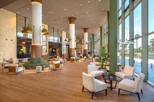 a lobby of a building with chairs and tables at Meliá Valencia in Valencia