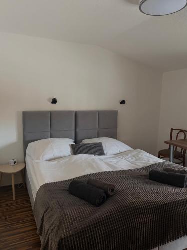 a bedroom with a large bed with two pillows on it at Penzión u Kastelána in Spišské Podhradie