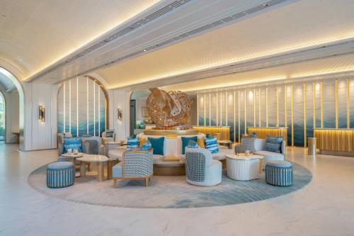 a lobby with blue and white chairs and tables at Meliá Pattaya Hotel in Pattaya