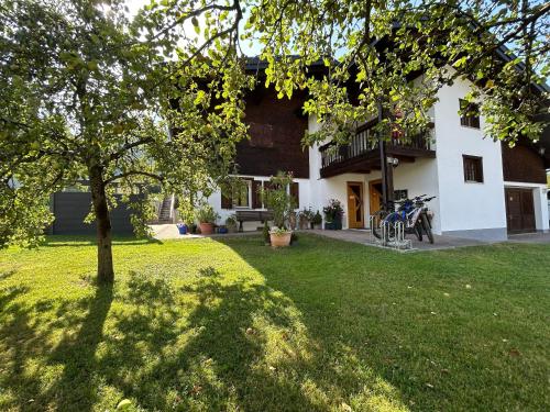 a house with a tree in the yard at Ferienwohnung Schneider in Vandans