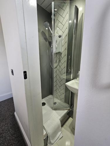 a bathroom with a shower and a sink at Edinburgh City Hotel in Edinburgh