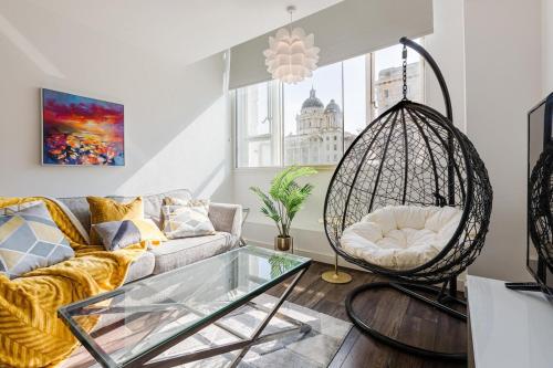 a living room with a couch and a swing at Liver Building View in Liverpool