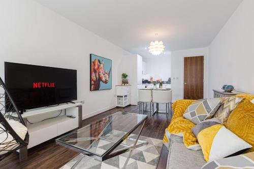 a living room with a couch and a tv at Liver Building View in Liverpool