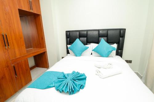a bedroom with a bed with a blue bow on it at Maraluxe Resoert & Spa in Nakuru