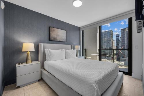 a bedroom with a white bed and a large window at Vibras Wellness in Miami