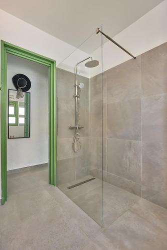 a shower with a glass door in a bathroom at Casita Helena in Torrox