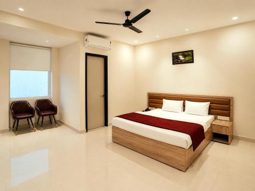 a bedroom with a bed and a ceiling fan at Hotel 33 Inn in Kānpur