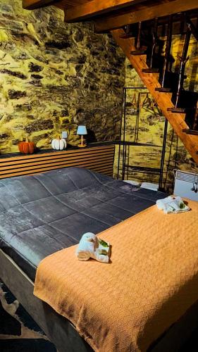 a bedroom with a bed with two towels on it at Refúgio do Casal in Lousã