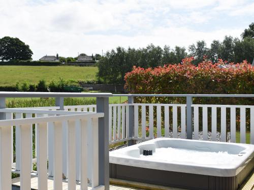 a bath tub sitting on top of a balcony at Pine Lodge - Uk30007 in Lindal in Furness