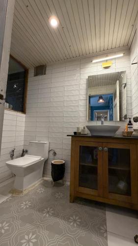 a bathroom with a tub and a sink and a toilet at MATANAI HOUSE X THHP - The Deck Villa Mukteshwar - 2 Bedroom Bonfire & BBQ in Mukteshwar
