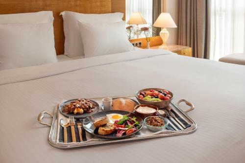 a tray of breakfast food on a bed at Meliá Athens in Athens