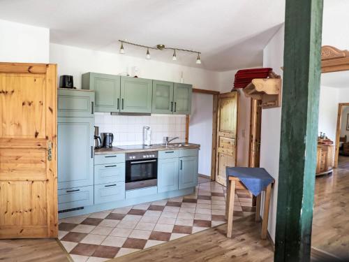 a kitchen with blue cabinets and a tile floor at Apartment Rügen by Interhome in Dargun