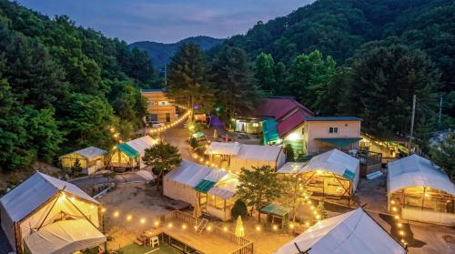 an aerial view of a campground with tents and lights at Pocheon Terrace 527 Campground in Pocheon