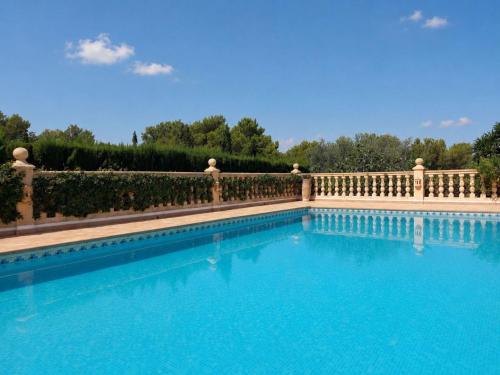a swimming pool with a fence and blue water at Villa Villa Lantana by Interhome in Jávea