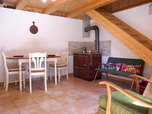 a kitchen and dining room with a table and chairs at Holiday Home Rustico Nurell by Interhome in Madra