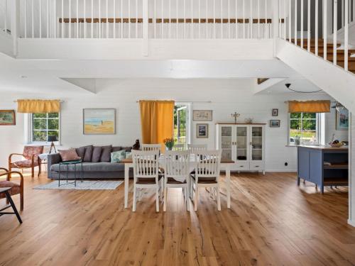 a dining room and living room with a table and chairs at Holiday Home Teåker by Interhome in Bäckefors