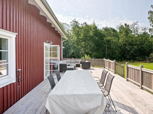 a patio with a table and chairs on a deck at Holiday Home Teåker by Interhome in Bäckefors