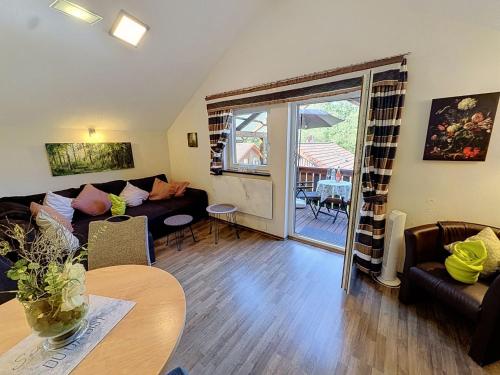a living room with a couch and a table at Apartment Petra by Interhome in Grafenwiesen