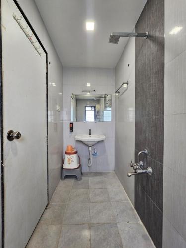 a bathroom with a sink and a toilet in it at Hotel Royal Residency Executive in Miraj