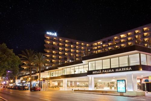 a large building at night with a street in front at Meliá Palma Marina in Palma de Mallorca