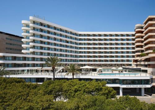 a large white building with trees in front of it at Meliá Palma Marina in Palma de Mallorca